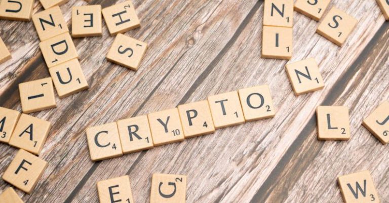 ICOs - Cryptocurrency scrabble letters on a wooden table