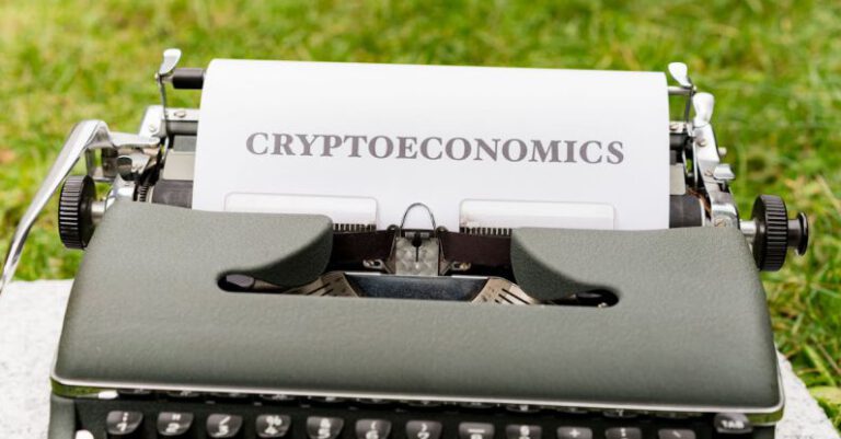 ICOs - A typewriter with the word cryptonomics on it