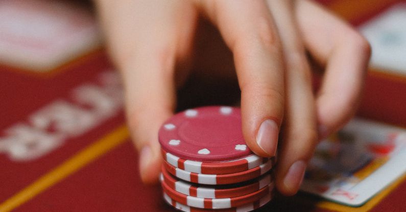 Tokens - A Person Holding Poker Chips