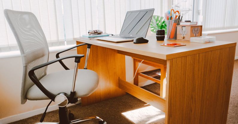 Business - White Rolling Armchair Beside Table