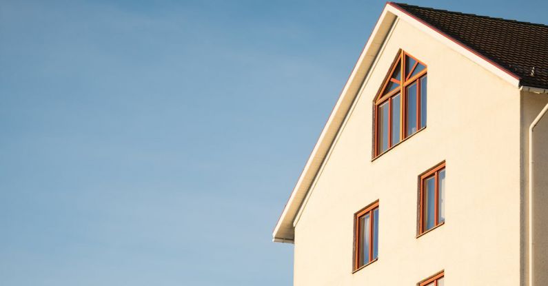 Investing - Beige Concrete House Under Cumulus Cloud