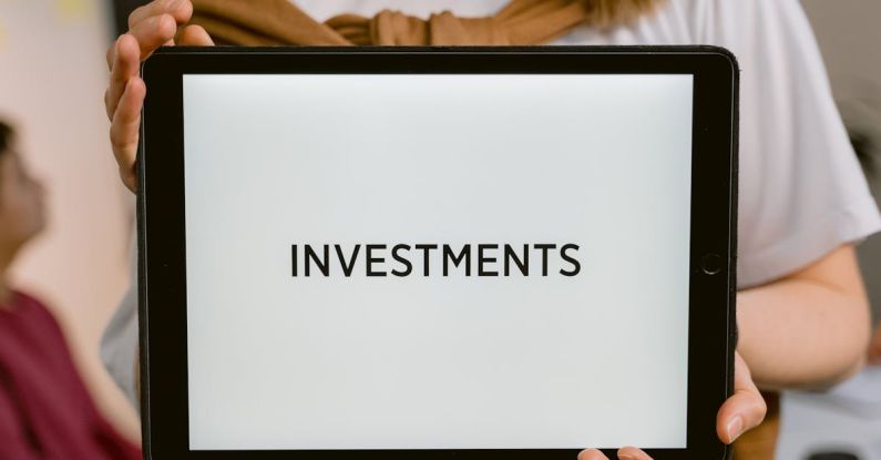 Investments - Close-Up Shot of a Person Holding a Tablet