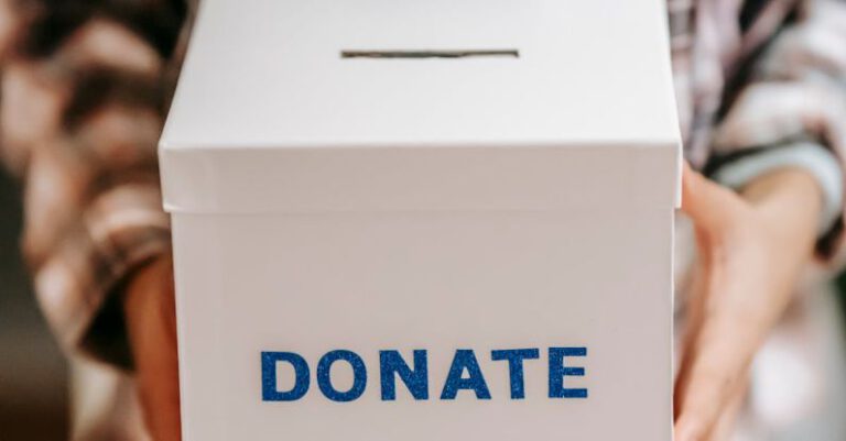 Benefits - Crop anonymous person showing donation box