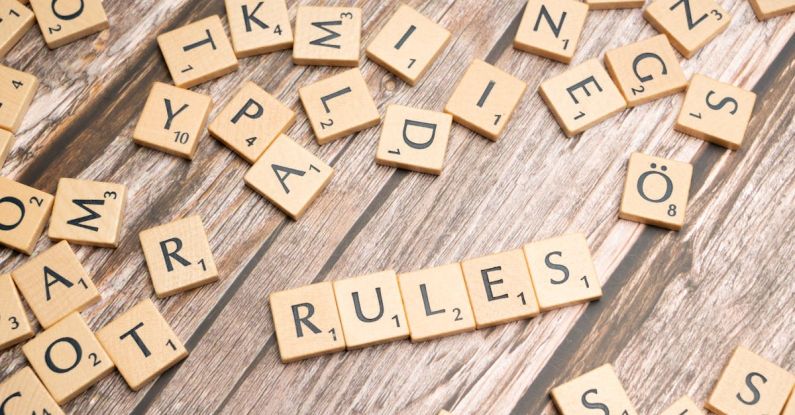 Protocols - Scrabble letters spelling rules on a wooden table